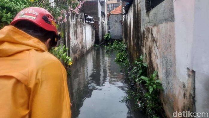 Sejumlah petugas Damkar Kota Surabaya melalukukan penyedotan saluran untuk mengatasi banjir di Dukuh Kupang, Surabaya, Selasa (9/1/2024).