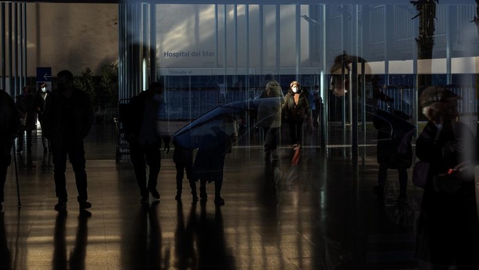 People wearing face masks as a precaution wait for a doctor appointment inside a hospital in Barcelona, Spain, Monday, Jan. 8, 2024. Regional and national health chiefs are meeting Monday to decide whether to extend mandatory mask—wearing to all health facilities following an epidemic outbreak of flu and other respiratory viruses that are putting a strain on the system. (AP Photo/Emilio Morenatti)