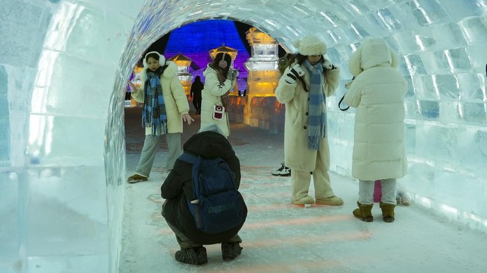 Tourists tour the annual Harbin Ice and Snow World in Harbin in northeastern China's Heilongjiang Province, Monday, Jan. 8, 2024. (AP Photo/Wayne Zhang)