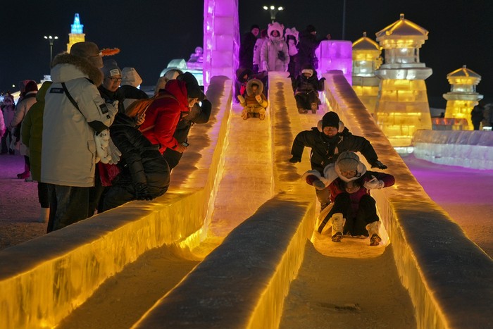 Tourists tour the annual Harbin Ice and Snow World in Harbin in northeastern Chinas Heilongjiang Province, Monday, Jan. 8, 2024. (AP Photo/Wayne Zhang)