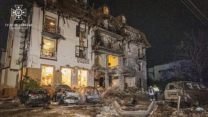 Rescuers stand at the site in the aftermath of a Russian missile strike on a hotel in Kharkiv, Ukraine, in this handout image released January 11, 2024. State Emergency Service of Ukraine/Handout via REUTERS Acquire Licensing Rights