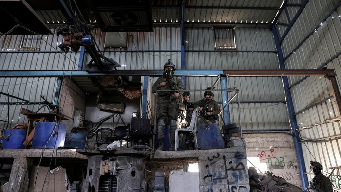 An Israeli soldiers inspects what the Israeli army said is a steel factory where rockets and other ammunition were produced, as he operates, amid the ongoing conflict between Israel and the Palestinian Islamist group Hamas, in Gaza, January 8, 2024. REUTERS/Ronen Zvulun EDITOR'S NOTE: REUTERS PHOTOGRAPHS WERE REVIEWED BY THE IDF AS PART OF THE CONDITIONS OF THE EMBED. TWO PHOTOS WERE REMOVED BY REUTERS UPON IDF REQUEST, CITING SECURITY CONCERNS. ONE SHOWED A TANK MARKING AND THE OTHER EXPOSED A LOCATION OF TROOPS     TPX IMAGES OF THE DAY