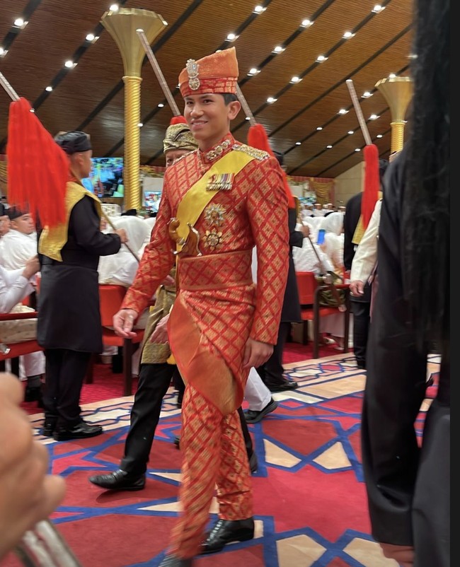 Anak ke-10 Sultan Hassanal Bolkiah itu tampil gagah dengan setelan pengantin tradisional Melayu yang dikenal sebagai sepangadak merah. Sesuai namanya, warna merah mendominasi busana yang terdiri dari kemeja model jas tutup dan celana panjang itu. Sepintas, materialnya menyerupai songket Sumatera. (Foto: Instagram/@tehfirdaus)