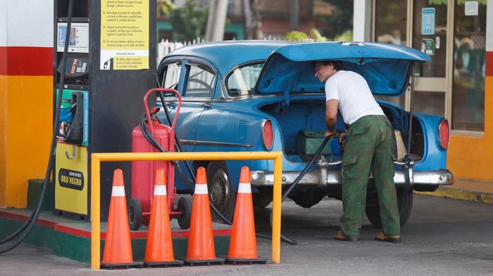 A man fills up a jerry can at a gas station, as the government announced it will hike the retail price of its 94 octane gasoline from 30 to 156 pesos per litre beginning February 1, in Havana, Cuba January 9, 2024. REUTERS/Yander Zamora
