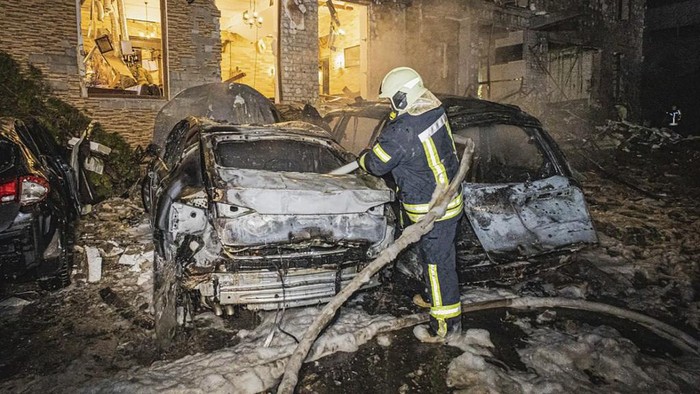 In this photo provided by the Ukrainian Emergency Service, a firefighter works to extinguish a fire after a Russia's missile attack that hit a hotel in Kharkiv, Ukraine, late Wednesday, Jan. 10, 2024. (Ukrainian Emergency Service via AP)