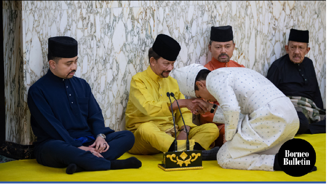 Pangeran Abdul Mateen yang merupakan anak ke-10 dari Sultan Brunei Hassanal Bolkiah bersama mantan istri kedua sang sultan, Puan Mariam binti Abdul Aziz tampak mencium tangan ayahnya setelah akad nikah. Foto: Dok. AFP, Borneo Buletin