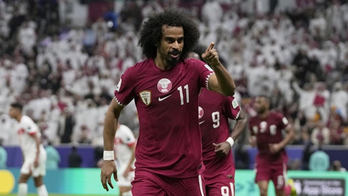Qatars Akram Afif celebrates after scoring the opening goal during the Asian Cup Group A soccer match between Qatar and Lebanon at the Lusail Stadium in Lusail, Qatar, Friday, Jan. 12, 2024. (AP Photo/Thanassis Stavrakis)