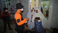 Relawan membagikan masker kepada jamaah masjid akibat hujan abu vulkanik, di Pokso Bencana Gunung Marapi, Batang Silasiah, Nagari Bukik Batabuah, Agam, Sumatera Barat.