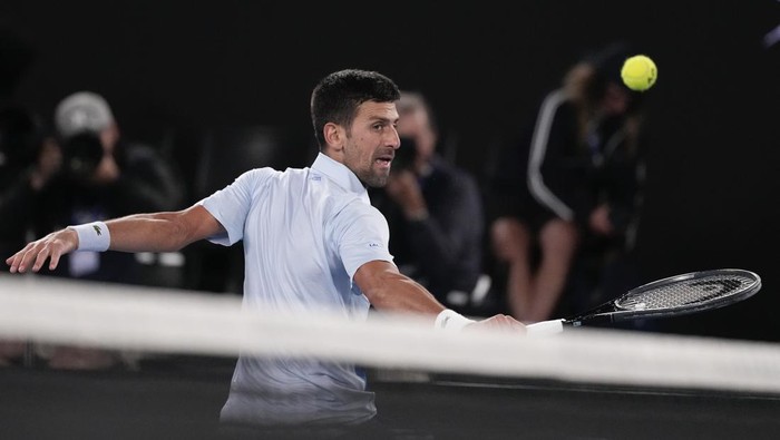 Serbias Novak Djokovic plays a backhand return to Croatias Dino Prizmic during their first round match at the Australian Open tennis championships at Melbourne Park, Melbourne, Australia, Sunday, Jan. 14, 2024. (AP Photo/Alessandra Tarantino)