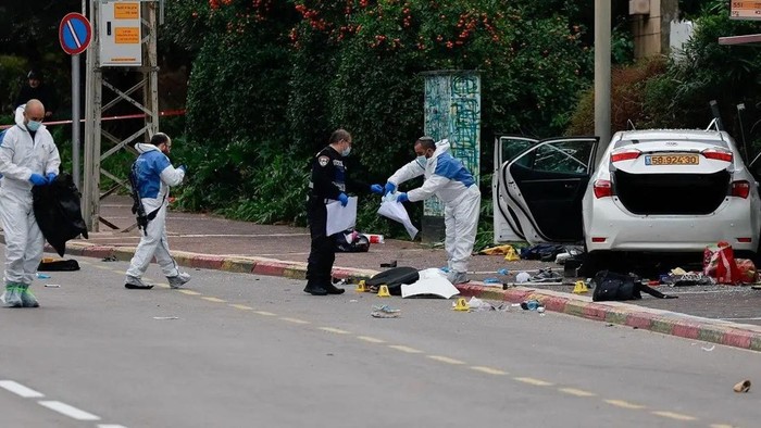 People work next to a vehicle following a suspected ramming attack in Raanana, Israel January 15, 2024. REUTERS/Ammar Awad