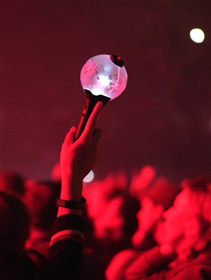 Bts k pop band fan raise hand up hold bomb light stick lamp. Fun korean people enjoy kpop live music concert. Crowd hang out cool night show. Asian idols army wave red flash light. Joy party fest tour