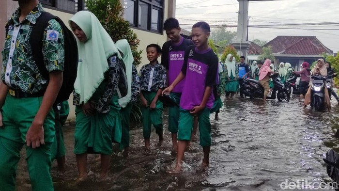 Sejumlah siswa-siswi SD dan SMP di Kabupaten Sidoarjo, semangat belajat meski sekolah mereka tergenang banjir, Kamis (18/1/2024).