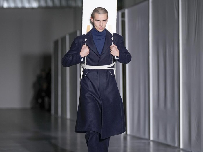 A model balances on top of another model wearing creations as part of the mens Federico Cina Fall-Winter 2024-2025 collection, that was presented in Milan, Italy, Saturday, Jan. 13, 2024. (AP Photo/Antonio Calanni).