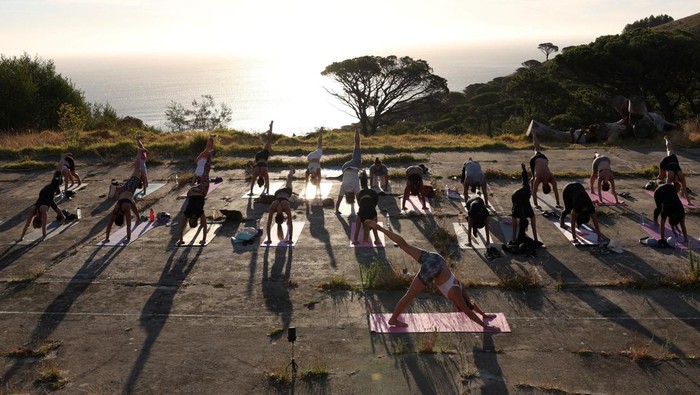 People perform yoga near Table Mountain in Cape Town, South Africa, January 18, 2024. REUTERS/Esa Alexander