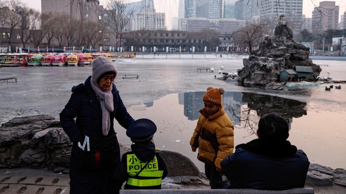 Elderly people spend time with children at a park in Beijing, China January 12, 2024. REUTERS/Tingshu Wang
