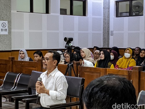 Mantan Wali Kota Bima Muhammad Lutfi ditemani isterinya, Ellya (jilbab hitam) di Pengadilan Negeri Tindak Pidana Korupsi Mataram, Senin (22/1/2024). (Ahmad Viqi/detikBali)