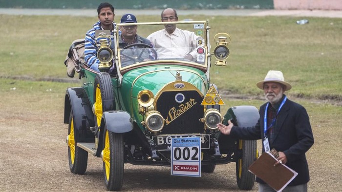 A 1913 Gebruder Stoewer moves on the turf as a marshall gestures during the 53rd Statesman Vintage & Classic Car Rally in Kolkata, India, Sunday, Jan. 21, 2024.  (AP Photo/Bikas Das)