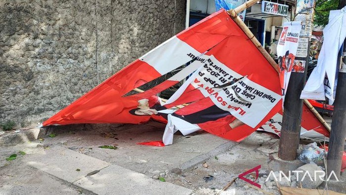 Salah satu baliho calon anggota legislatif (caleg) Partai Solidaritas Indonesia (PSI) yang roboh telah dipindahkan ke pinggir jalan usai menimpa pengendara motor di Jalan KRT Radjiman Widyoningrat, Kelurahan Jatinegara, Kecamatan Cakung, Jakarta Timur, Senin (22/1/2024).