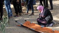 Seorang wanita bereaksi ketika orang-orang menguburkan jenazah warga Palestina yang tewas dalam serangan Israel, di gedung rumah sakit Nasser 22 Januari 2024. REUTERS/Ahmed Zakot. 