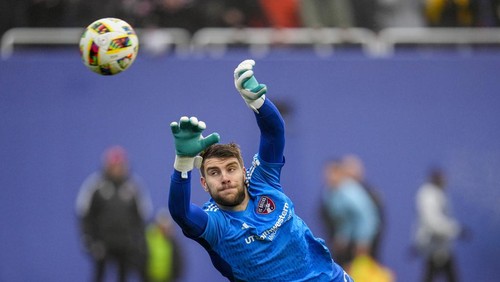 FC Dallas goalkeeper Maarten Paes dives on a shot by Inter Miami during the first half of a preseason friendly MLS soccer match Monday, Jan. 22, 2024, at the Cotton Bowl in Dallas. The shot went wide of his net. (AP Photo/Julio Cortez)