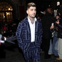Zayn Malik tampak mengenakan sneakers putih, juga dari koleksi terbaru Kenzo. Foto: Swan Gallet/WWD via Getty Images