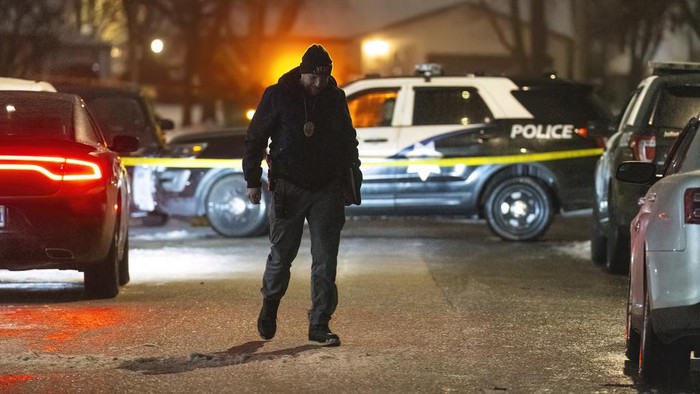 Police work a scene, Monday, Jan. 22, 2024, in Joliet, Ill., after multiple people were shot and killed over two days at three locations in the Chicago suburbs. (Tyler Pasciak LaRiviere/Chicago Sun-Times via AP)