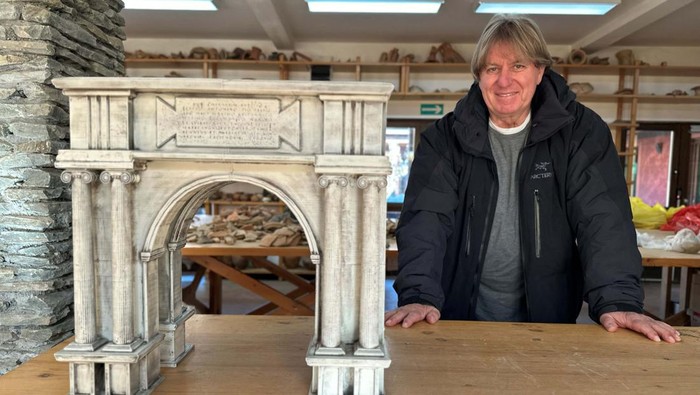 Miomir Korac, the leading archaeologist, poses next to a maquette of an ancient Roman triumphal arch, the remains of which were discovered at the site of Viminacium, a former Roman settlement near the town of Kostolac, Serbia, January 22, 2024. REUTERS/Branko Filipovic