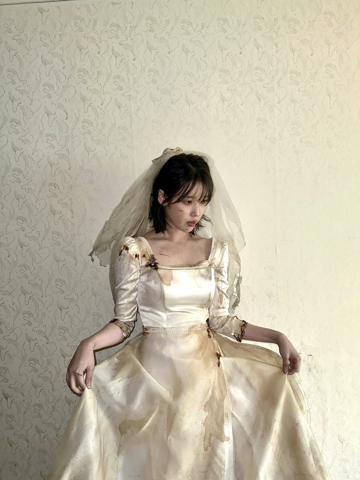 Foto belakang layar MV IU Love Wins All yang diperankan IU dan V BTS. MV ini disutradarai Um Tae Hwa dari film Concrete Utopia.