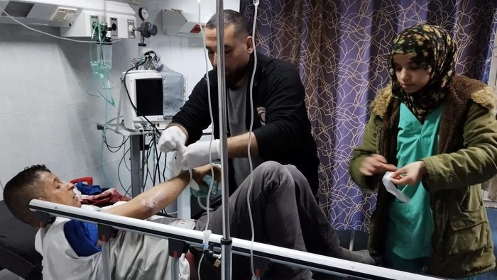 An injured Palestinian man receives medical assistance at Al-Amal Hospital, amid the ongoing conflict between Israel and the Palestinian Islamist group Hamas, in Khan Younis, Gaza Strip, in this handout image released on January 23, 2024. Palestine Red Crescent Society/Volunteer Ameer Abu Aisha/Handout via REUTERS    THIS IMAGE HAS BEEN SUPPLIED BY A THIRD PARTY. NO RESALES. NO ARCHIVES. MANDATORY CREDIT.