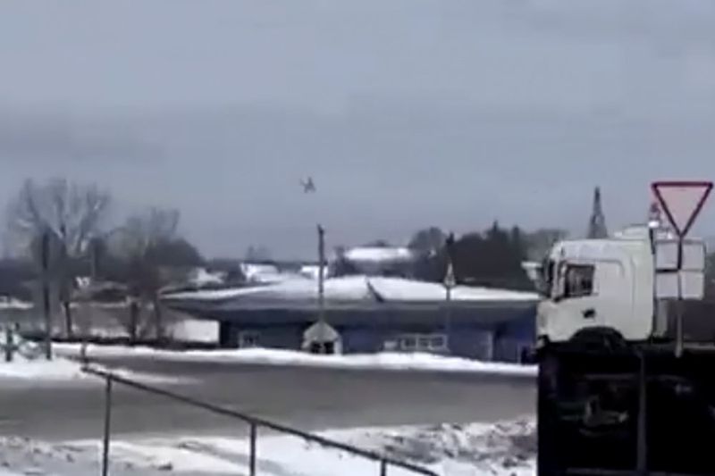 In this photo taken from validated UGC video a warplane flies before a crash at a residential area near Yablonovo, Belgorod region, Wednesday, Jun. 23, 2024. Russia says a military transport plane that was carrying 65 Ukrainian prisoners of war has crashed in a Russian region near Ukraine. (Validated UGC video via AP)