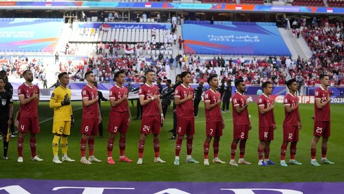 Indonesian players respect to their national anthem during the Asian Cup Group D soccer match between Japan and Indonesia at Al Thumama in Doha, Qatar, Wednesday, Jan. 24, 2024. (AP Photo/Thanassis Stavrakis)