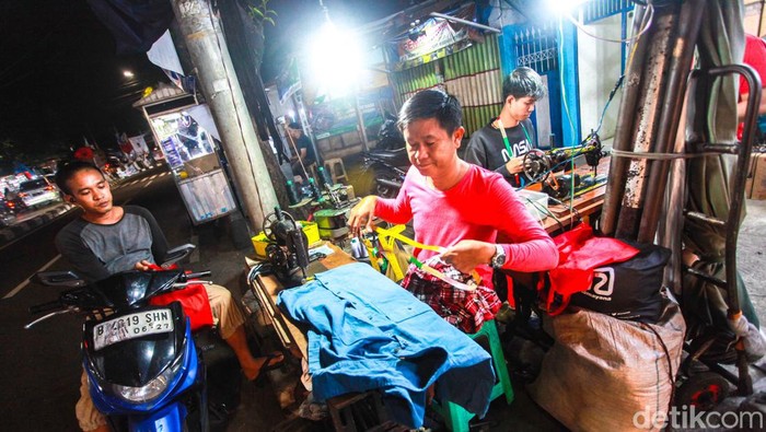 Tak seperti kebanyakan penjahit pada umumnya. Mereka menggelar jasanya di pinggir jalan hingga menjelang tengah malam.