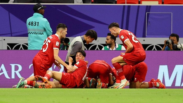 Soccer Football - AFC Asian Cup - Group D - Indonesia v Iraq - Ahmad bin Ali Stadium, Al Rayyan, Qatar - January 15, 2024  Indonesias Marselino Ferdinan celebrates scoring their first goal with teammates REUTERS/Ibraheem Al Omari