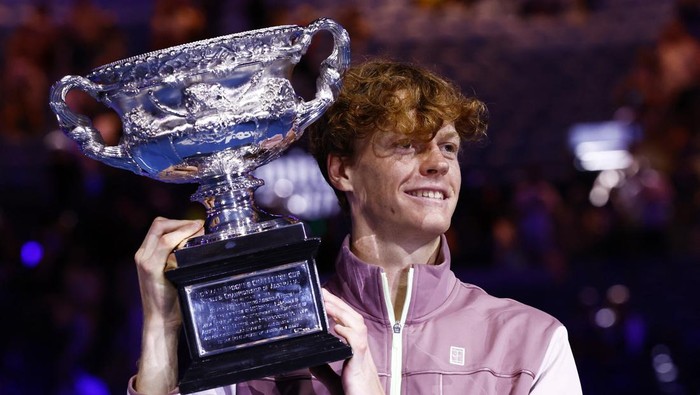 Tennis - Australian Open - Melbourne Park, Melbourne, Australia - January 28, 2024 Italys Jannik Sinner celebrates with the trophy after winning the final against Russias Daniil Medvedev REUTERS/Issei Kato