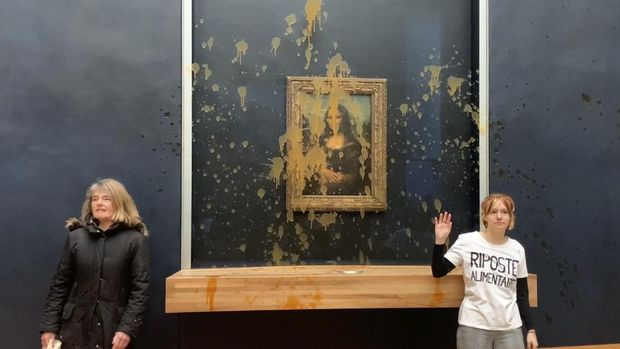 In this grab taken from video, a view of the scene after activists hurled soup at the glass protecting the Mona Lisa, at the Louvre Museum, in Paris, Sunday. Jan. 28, 2024. The two activists shouted slogans advocating for a sustainable food system. It comes as French farmers have been protesting for days across the country against several issues, including low wages.  (AP Photo/Clement Lanot)