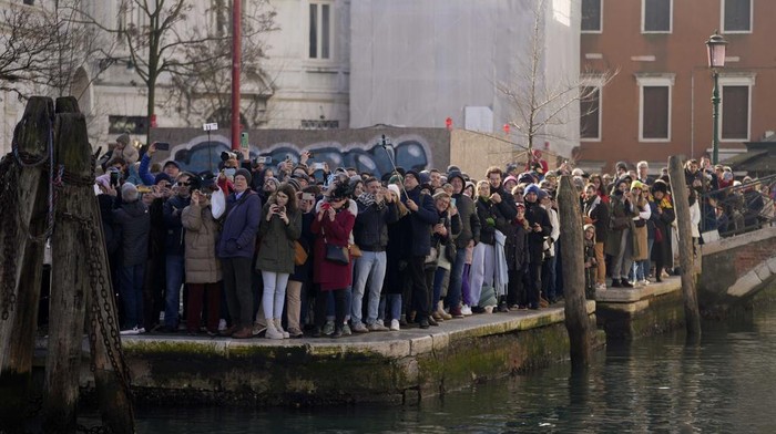 Boats sail as confetti explodes in the air during the traditional opening rowing parade, part of the Venice Carnival in Venice, Italy, Sunday Jan. 28, 2024. This year's edition 