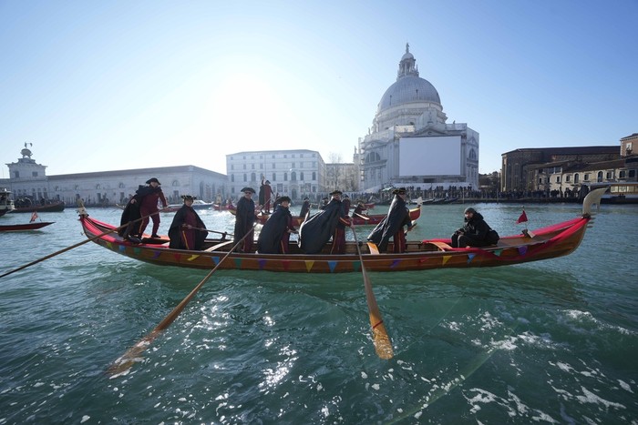 Boats sail as confetti explodes in the air during the traditional opening rowing parade, part of the Venice Carnival in Venice, Italy, Sunday Jan. 28, 2024. This years edition 