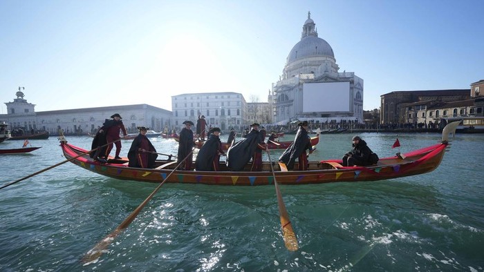 Boats sail as confetti explodes in the air during the traditional opening rowing parade, part of the Venice Carnival in Venice, Italy, Sunday Jan. 28, 2024. This years edition 