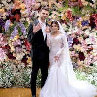 Sarah tampil glamor dalam gaun putih sheer bersiluet mermaid yang menonjolkan lekuk tebuhnya. Gaya perempuan 27 tahun itu kian lengkap dengan veil senada yang menjuntai hingga menyapu lantai. Adapun mempelai pria bersolek serasi dengan setelan model tuksedo yang dipadu dasi putih.  (Foto: Instagram)