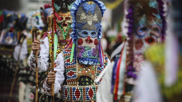 Masked Bulgarian dancers, wearing elaborated colourful costumes perform during the 30th International Festival of Masquerade Games 