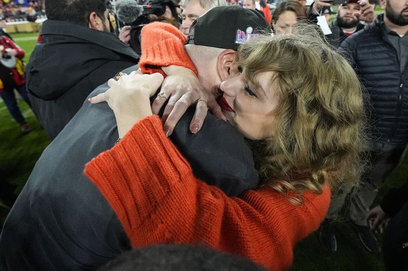 Taylor Swift speaks with Kansas City Chiefs tight end Travis Kelce after an AFC Championship NFL football game against the Baltimore Ravens, Sunday, Jan. 28, 2024, in Baltimore. The Kansas City Chiefs won 17-10. (AP Photo/Julio Cortez)