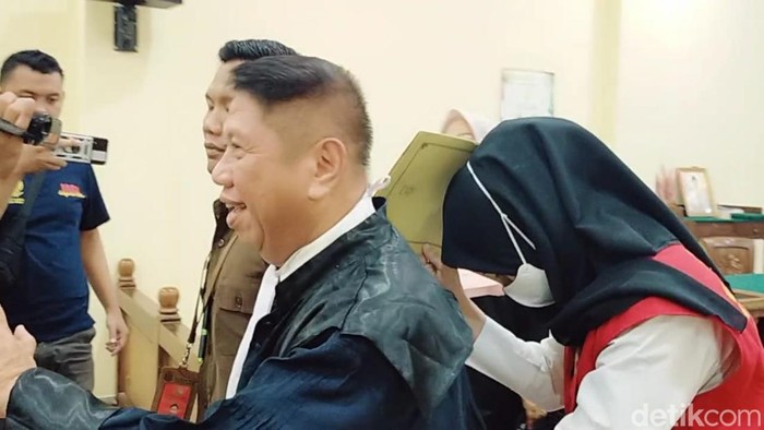 Adelia terus menutupi wajahnya dari sorot awak media selama sidang perdana kasus keterlibatan jaringan narkoba Fredy Pratama di PN Bandar Lampung.