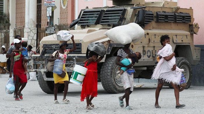 Hindari Geng Bersenjata, Warga Haiti Kabur dari Rumah Residents carry belongings as they leave their homes due to gang violence, in the Pernier section of Port-au-Prince, Haiti January 30, 2024. REUTERS/Ralph Tedy Erol