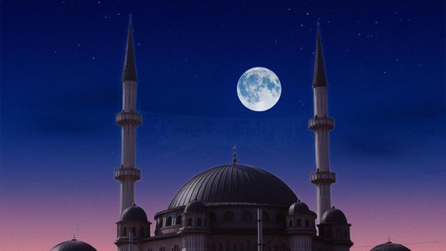 A full moon is seen over a taksim mosque in istanbul.