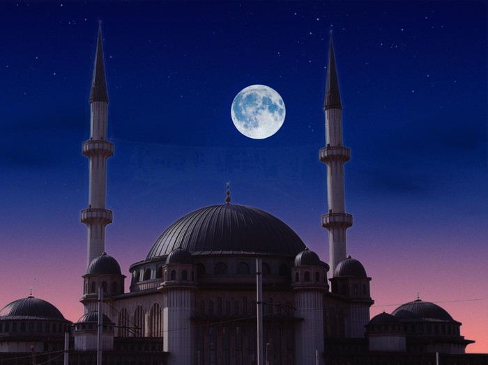 A full moon is seen over a taksim mosque in istanbul.