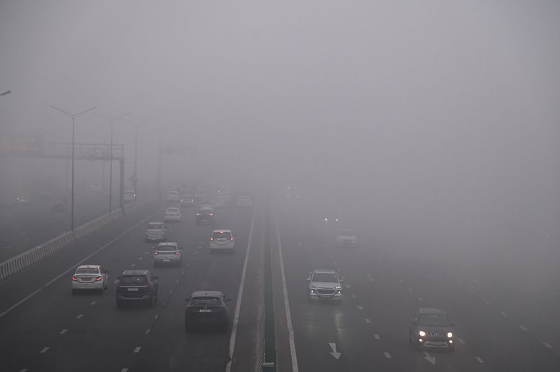 Traffic is passing through a highway amidst dense fog in New Delhi, India, on January 31, 2024. (Photo by Kabir Jhangiani/NurPhoto via Getty Images)