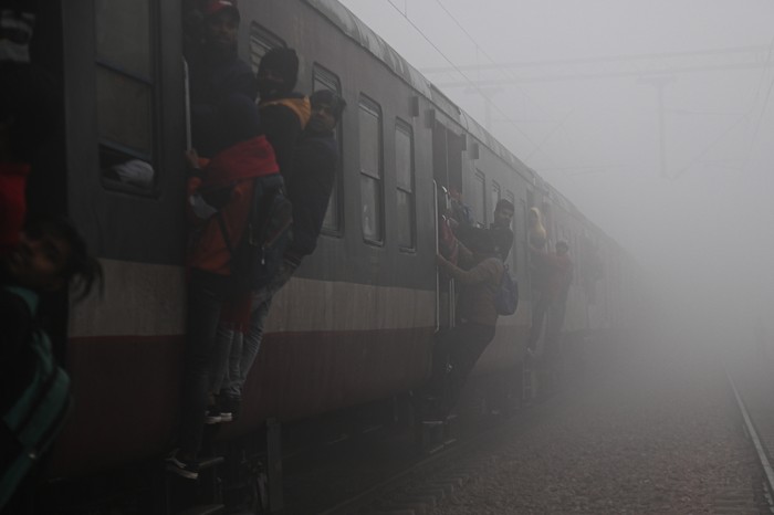 People are traveling on an overcrowded train on the outskirts of New Delhi, India, on January 31, 2024. Indian Prime Minister Narendra Modis government is preparing to announce its final budget on February 1, 2024, ahead of the Indian General Elections that will be held across the country. (Photo by Kabir Jhangiani/NurPhoto via Getty Images)