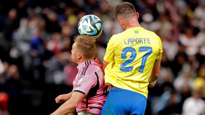 Inter Miamis Ukrainian defender #27 Sergii Kryvtsov and Nassrs French defender #27 Aymeric Laporte vie for a header during the friendly football match between Saudi Arabias al-Nassr FC and the US Inter Miami CF at the Kingdom Arena Stadium in Riyadh on February 1, 2024. (Photo by AFP)