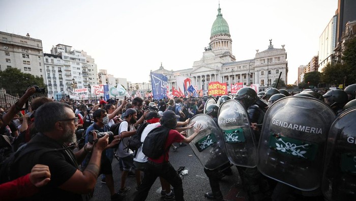 Demonstrators clash with law enforcement officers during a protest as lawmakers debate on Argentinas President Javier Mileis economic reform bill, known as the 