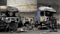 Seorang pria berjalan melewati truk yang terbakar setelah ledakan di depot pengisian ulang tabung gas darurat di perkebunan Mradi, distrik Embakasi, di Nairobi, Kenya, 2 Februari 2024.